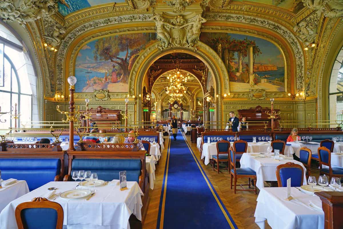 View of the landmark Belle Epoque Le Train Bleu restaurant inside the historic Gare de Lyon train station, built for the 1900 Paris World Exposition.