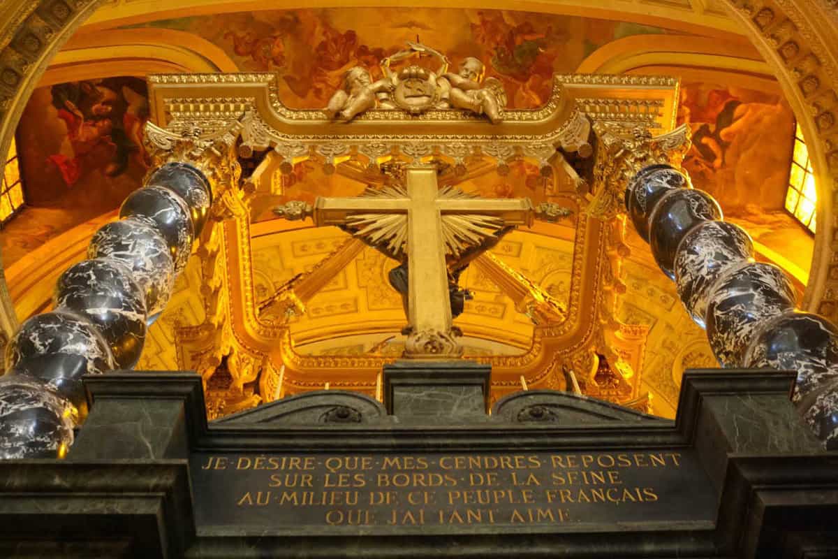 Interior of the Invalides where there is a cross on a podium