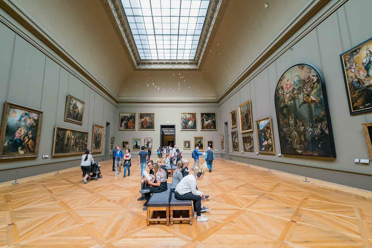 Gallery with framed masterpieces on the green walls