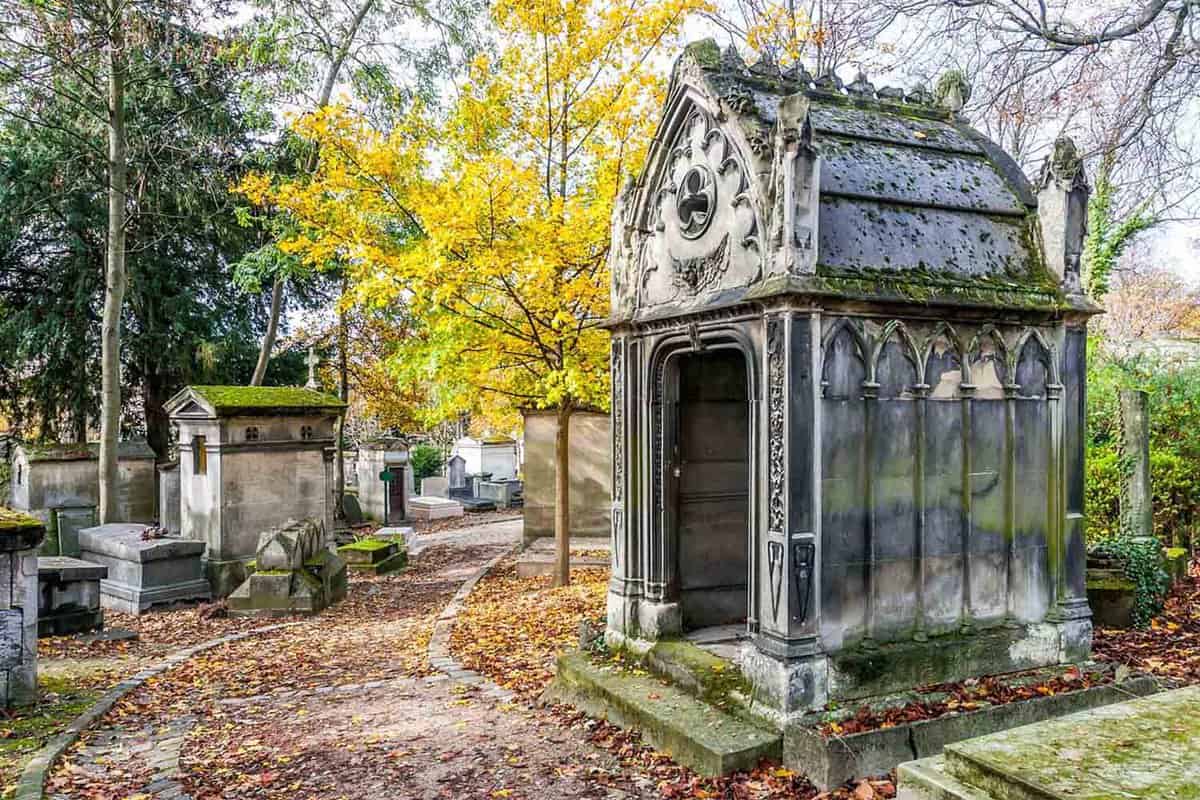 A view of a small old archway inside the cemetery during autumn