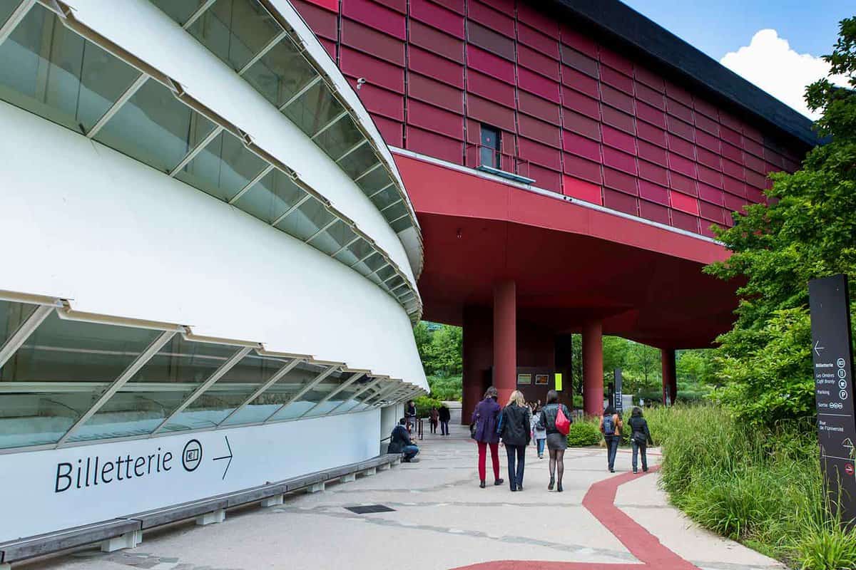Close up of a section of the exterior, a striking building . People walking on a pathway