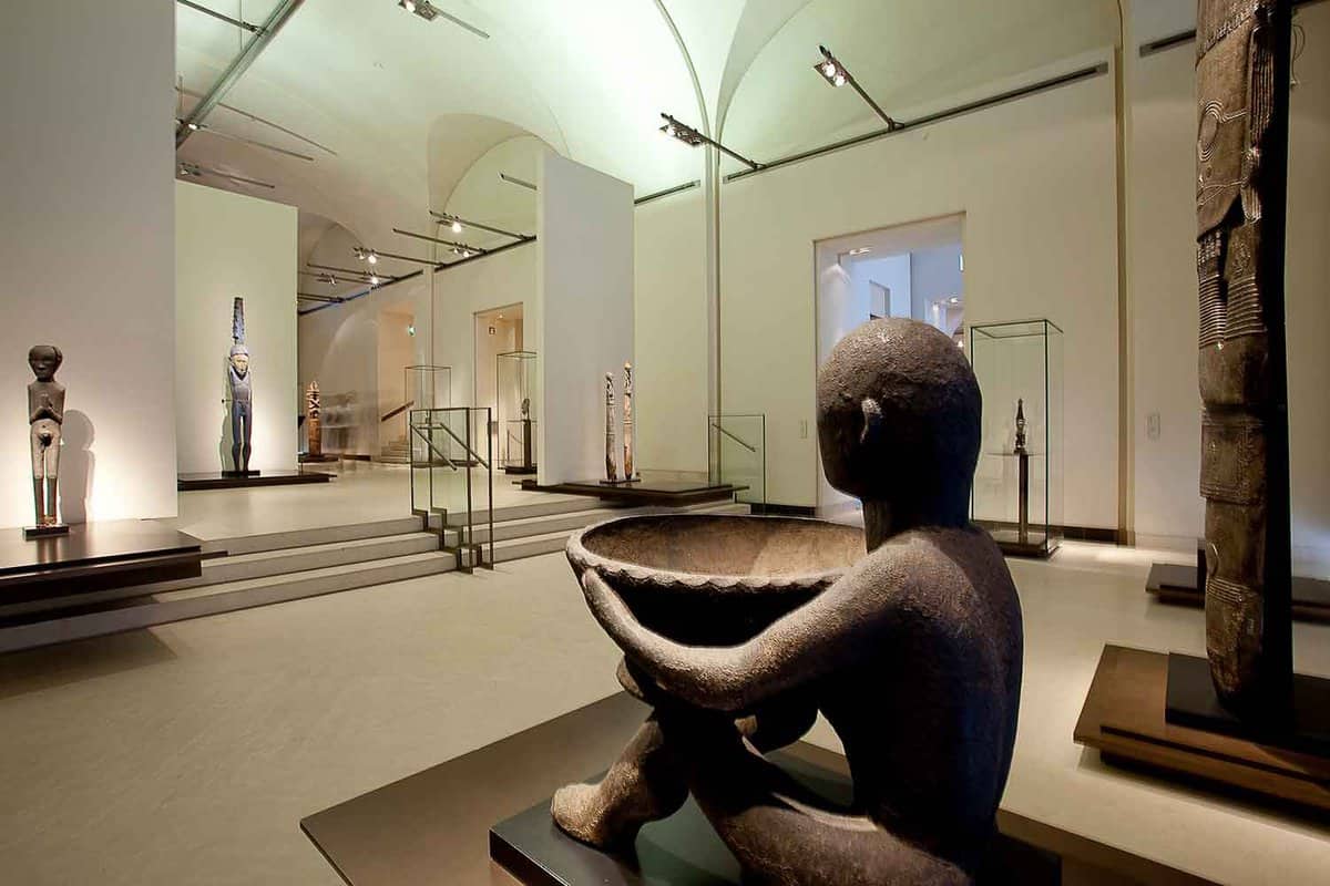 Interior galleries showing African carvings and statues in glass cases