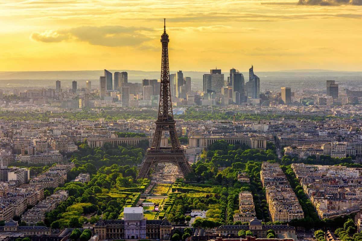 Aerial view of Paris with the Eiffel Tower in frame against a beautiful golden sunset