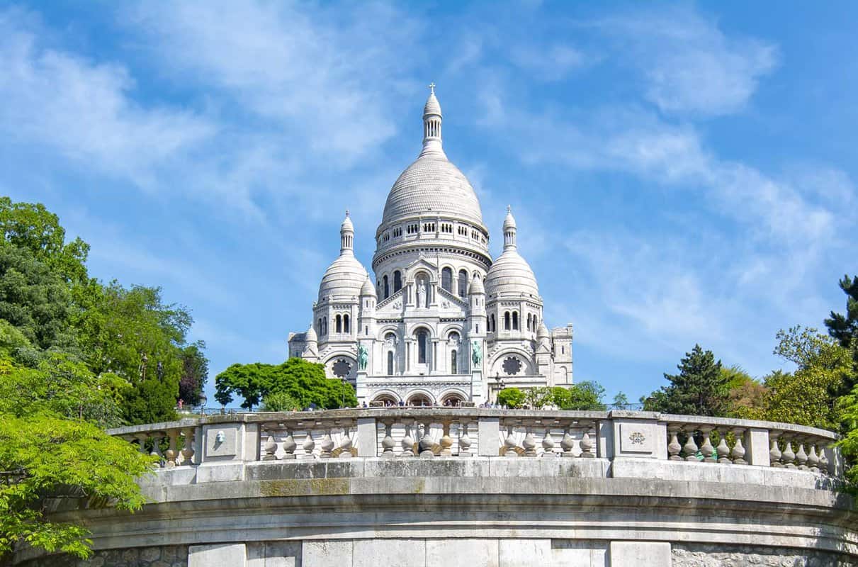 external view of the white Basilica sitting on Montmartre hill
