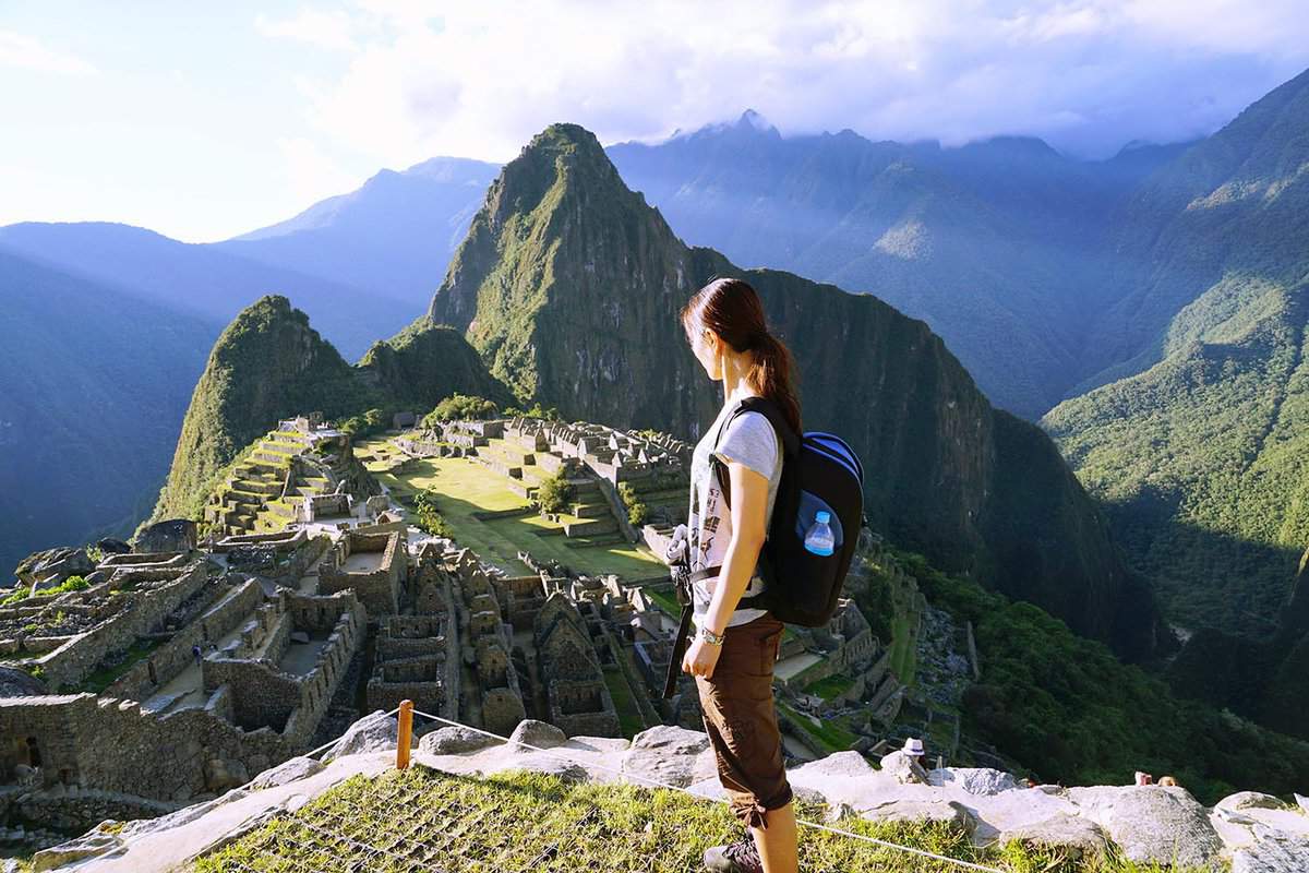 A traveller looks at Machu Picchu from a viewpoint