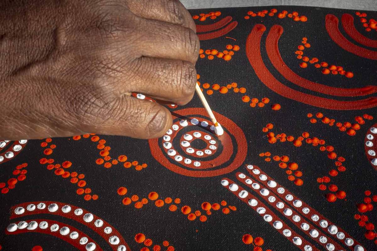 Aboriginal art, white and red dots to form shapes.