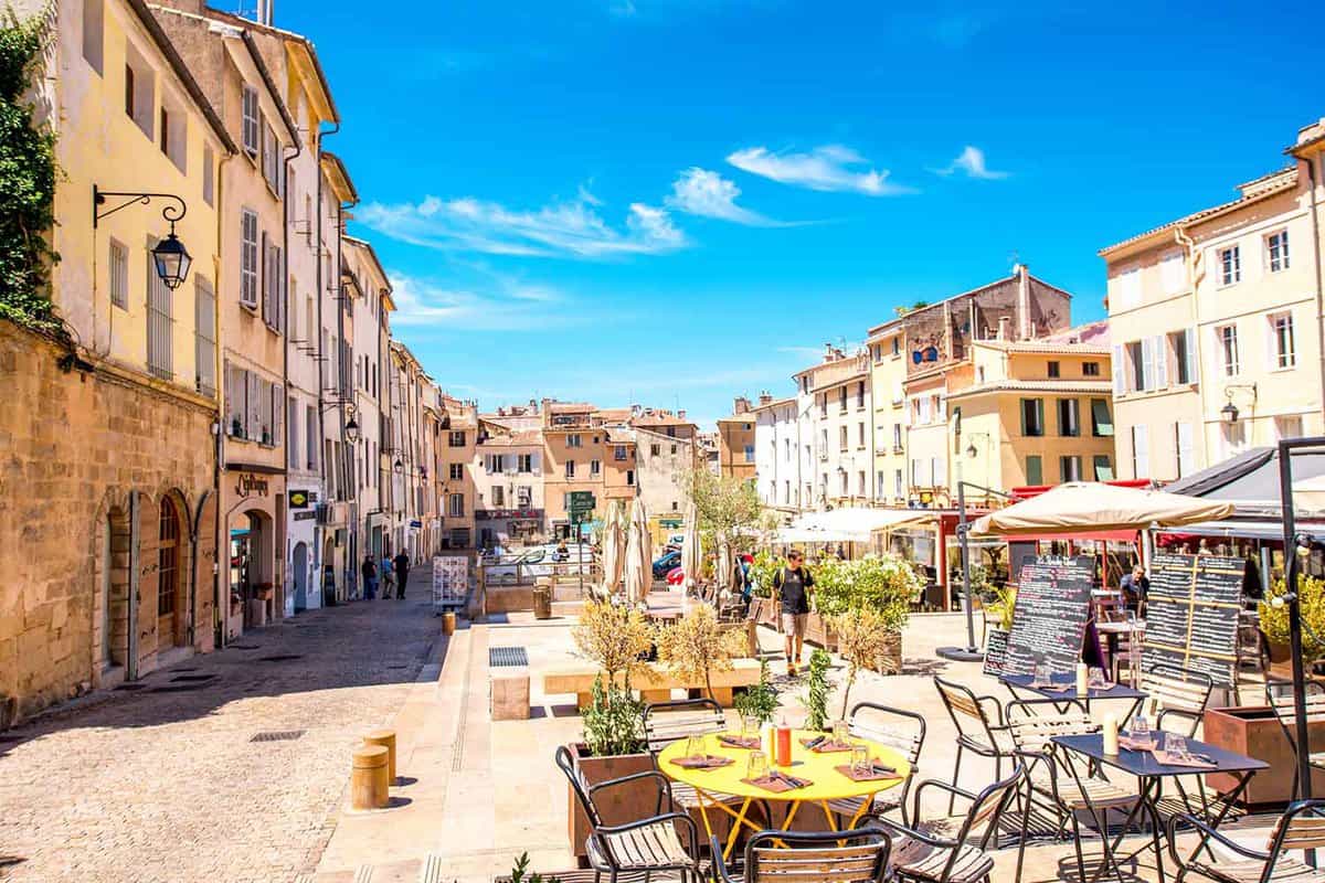 Sunny cardeurs square with cafes and restaurants in the old town of Aix-en-Provence.