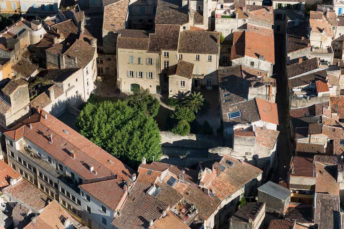 An aerial view of Arles, with red-roofed buildings visible