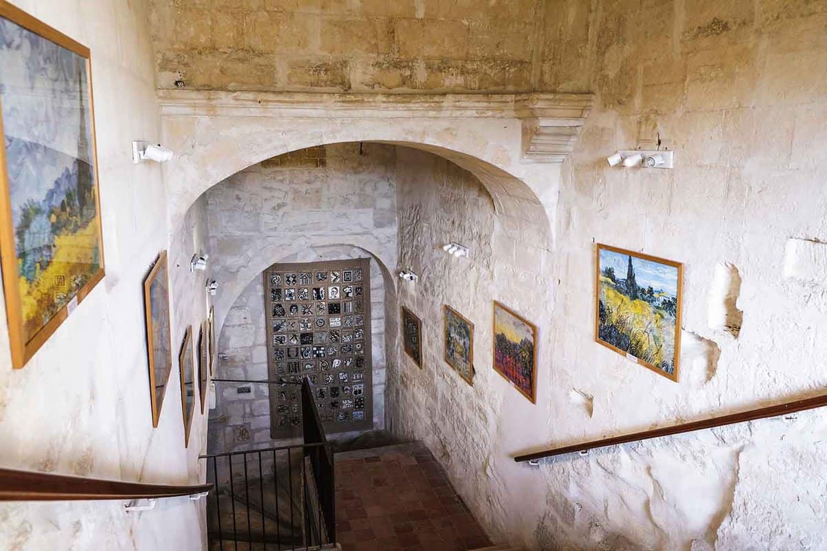 A staircase with paintings on the wall
