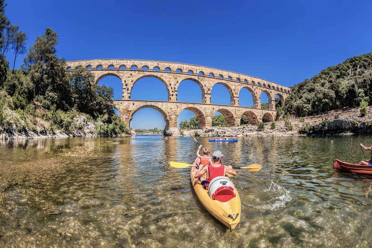 Kayakers on the river approaching the aqueduct