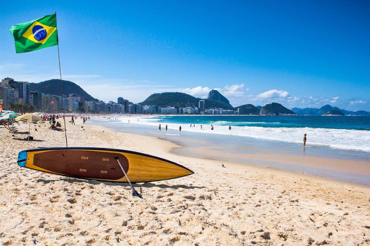 Surf board on sandy beach in day
