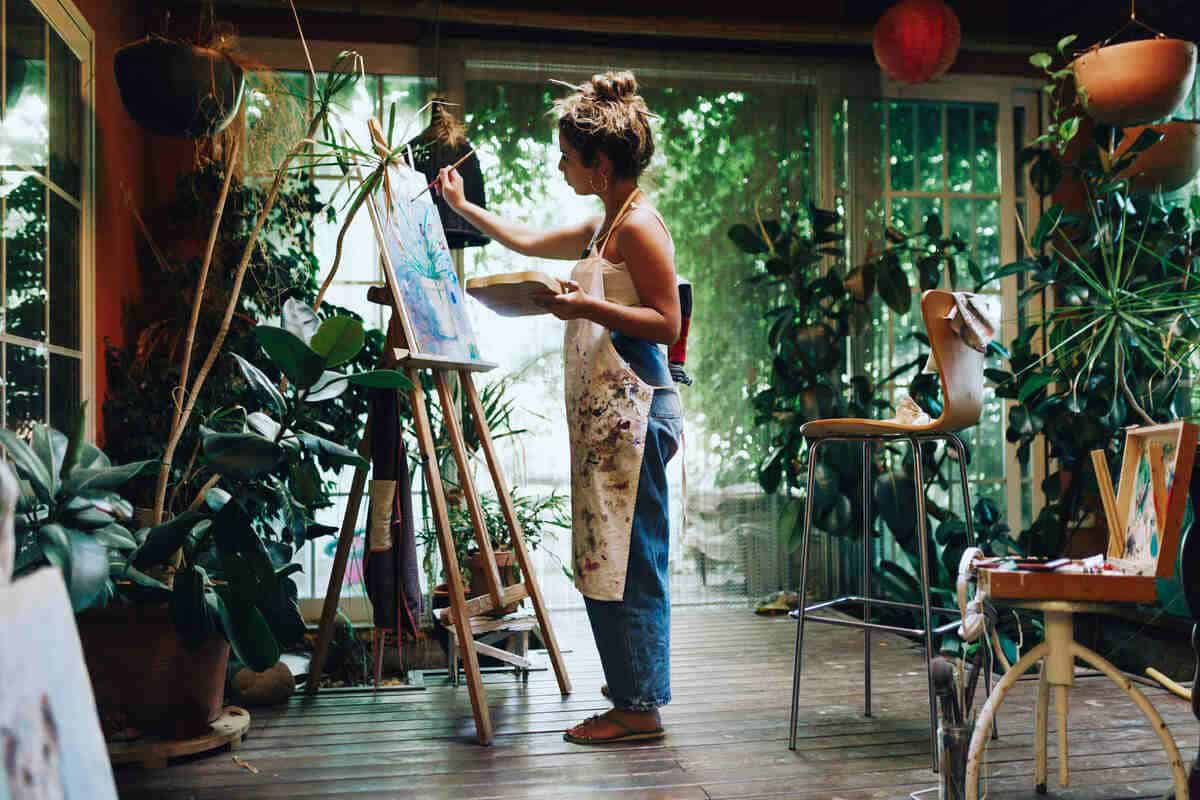 Female artists painting on a canvas