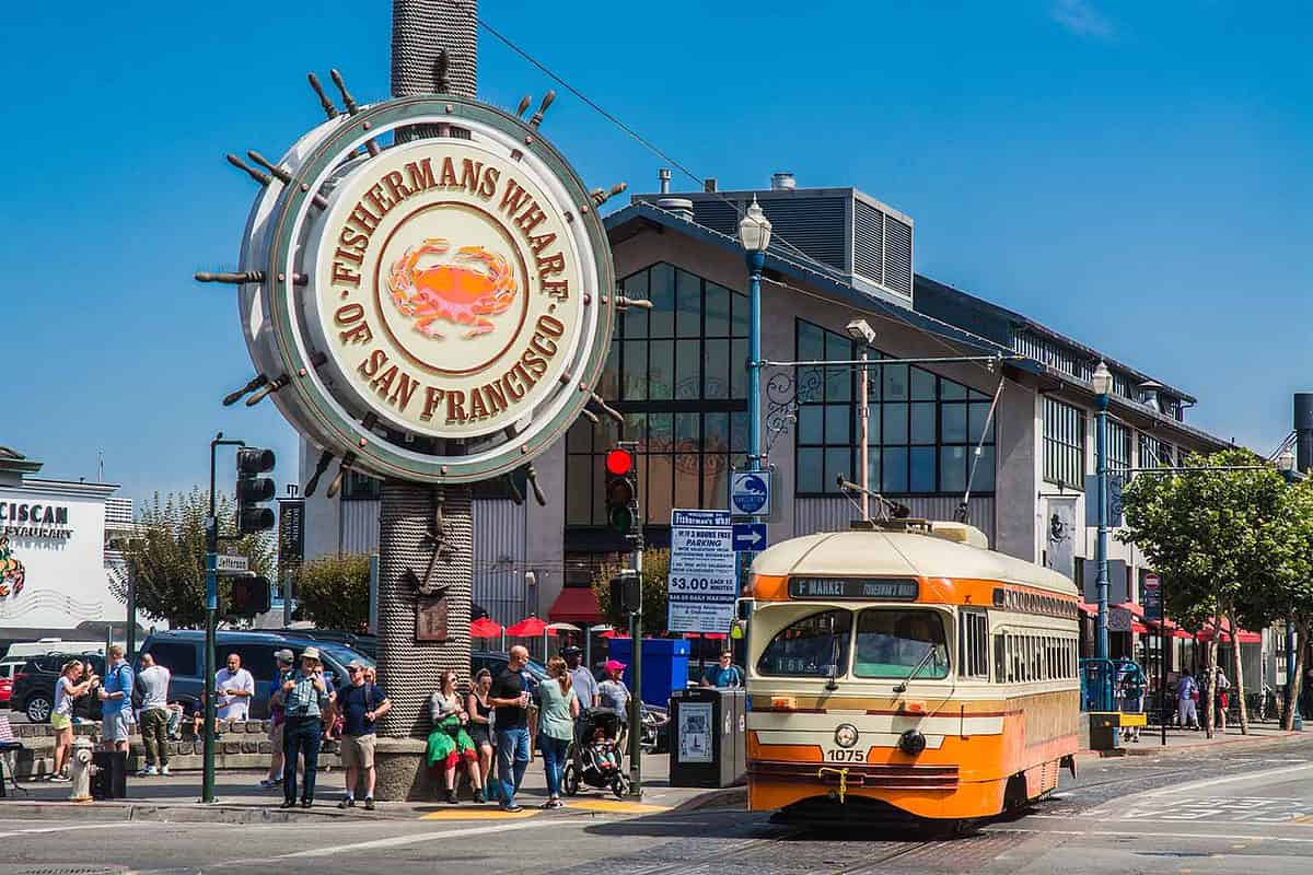 fisherman's wharf sign with bus out front