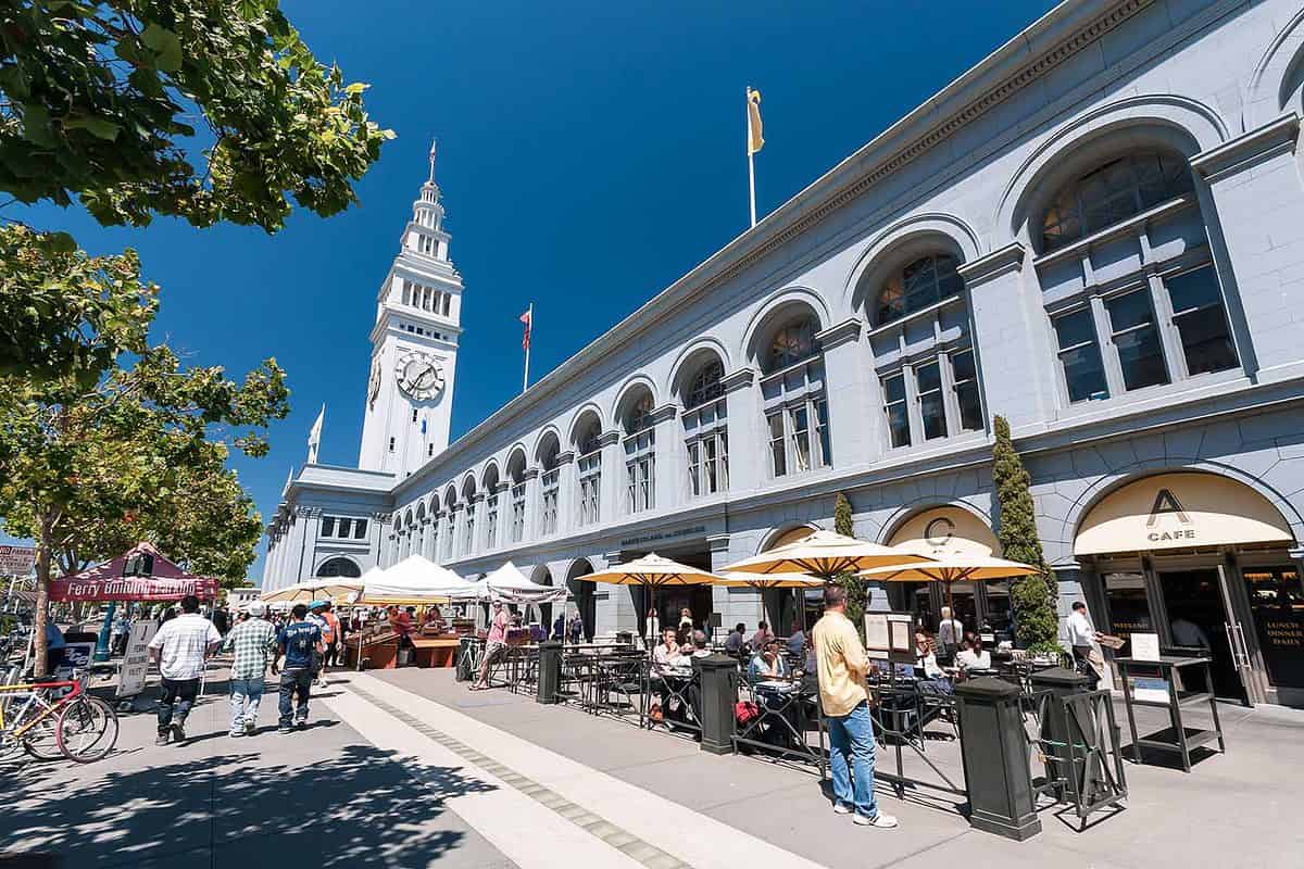 Exterior of the Ferry Building, with tables and chairs for outside dining