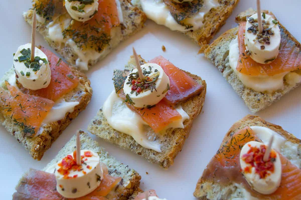 Spanish tapas, called pintxos of the Basque Country. Pintxos, tapas, Spanish canapes. Party finger food. With cheese, salmon and toasted bread.