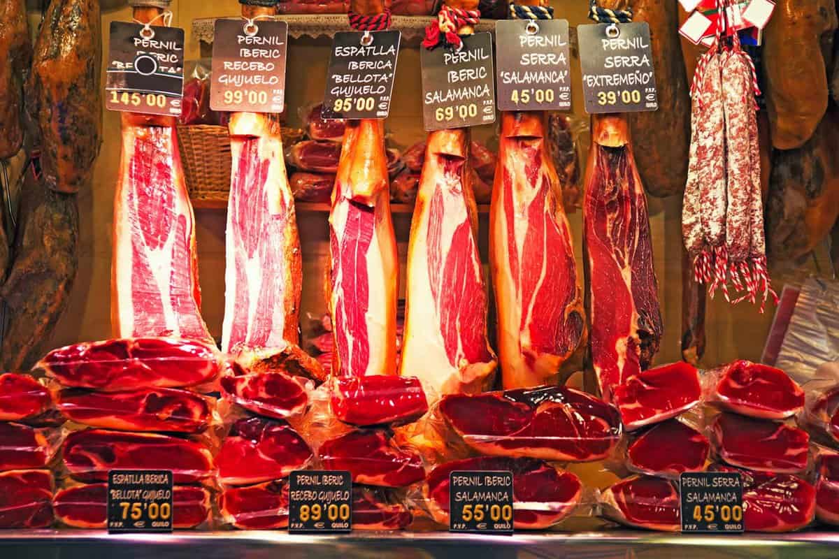 Spanish ham hanging on a stall in the Boqueria market in Barcelona.