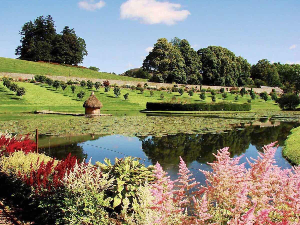 Beautiful landscaped gardens with a large pond in the foreground
