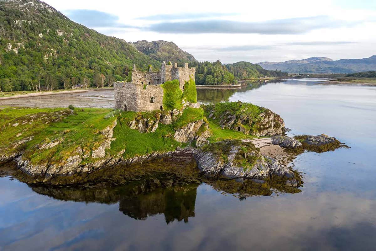 Aerial drone shot of Castle Tioram, it is a ruined castle that sits on the tidal island Eilean Tioram in Loch Moidart, Lochaber, Highland, Scotland. It is located west of Acharacle, approximately 80 k