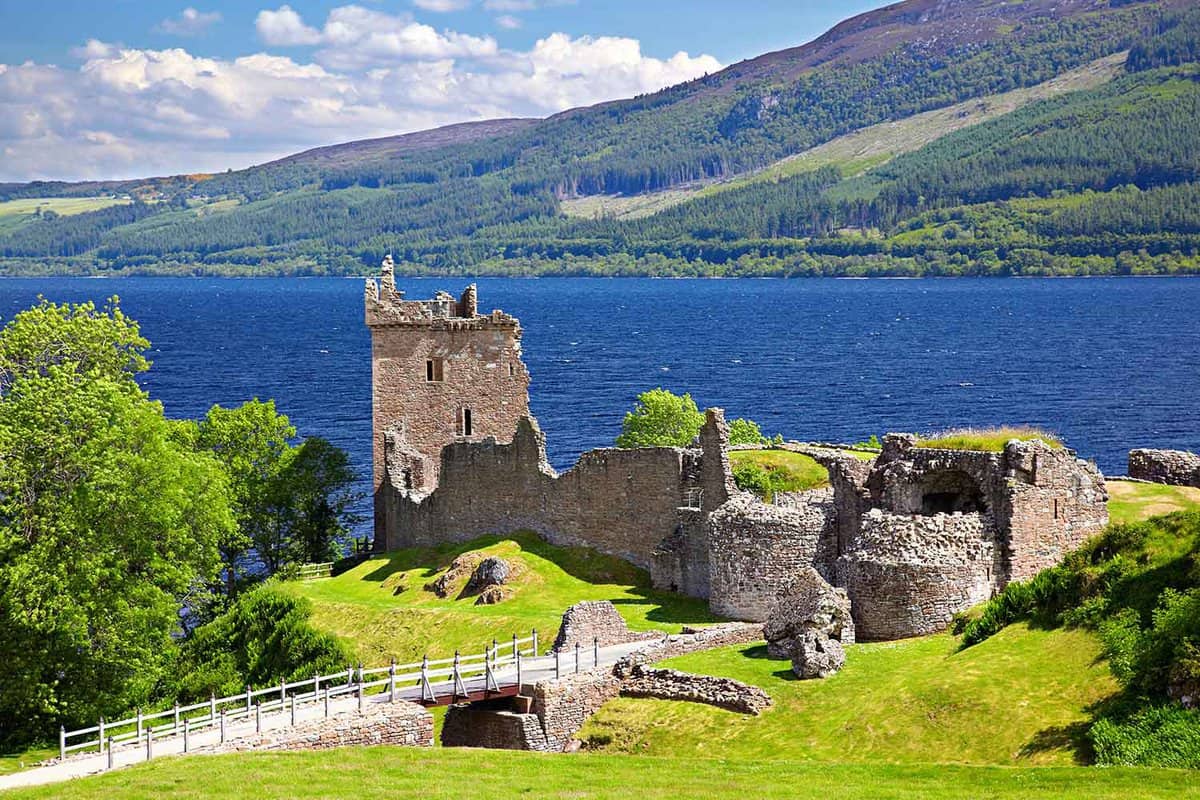 Atmospheric castle ruins on a sunny day with loch behind