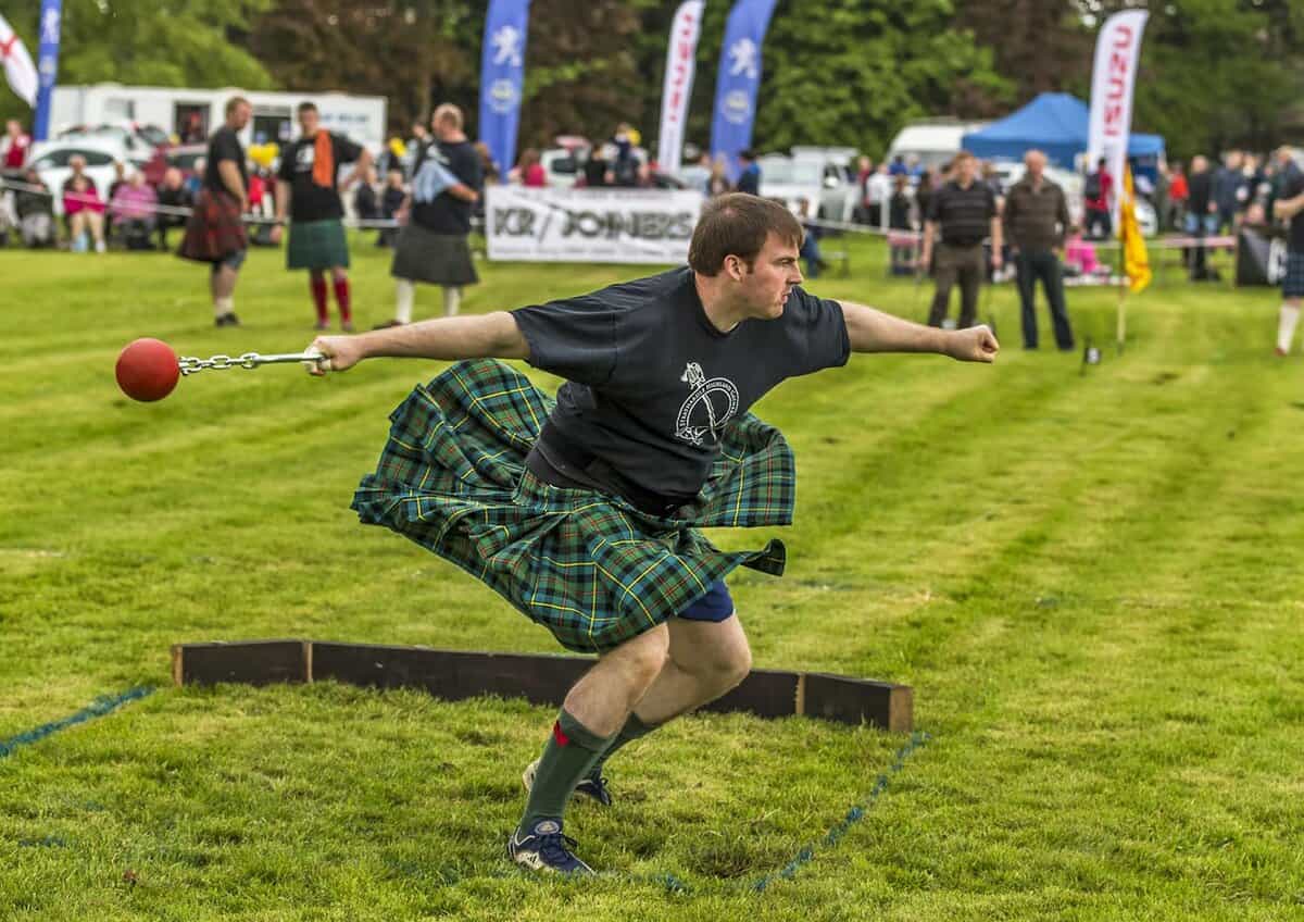 Man in a kilt tossing the hammer at the Highland Games