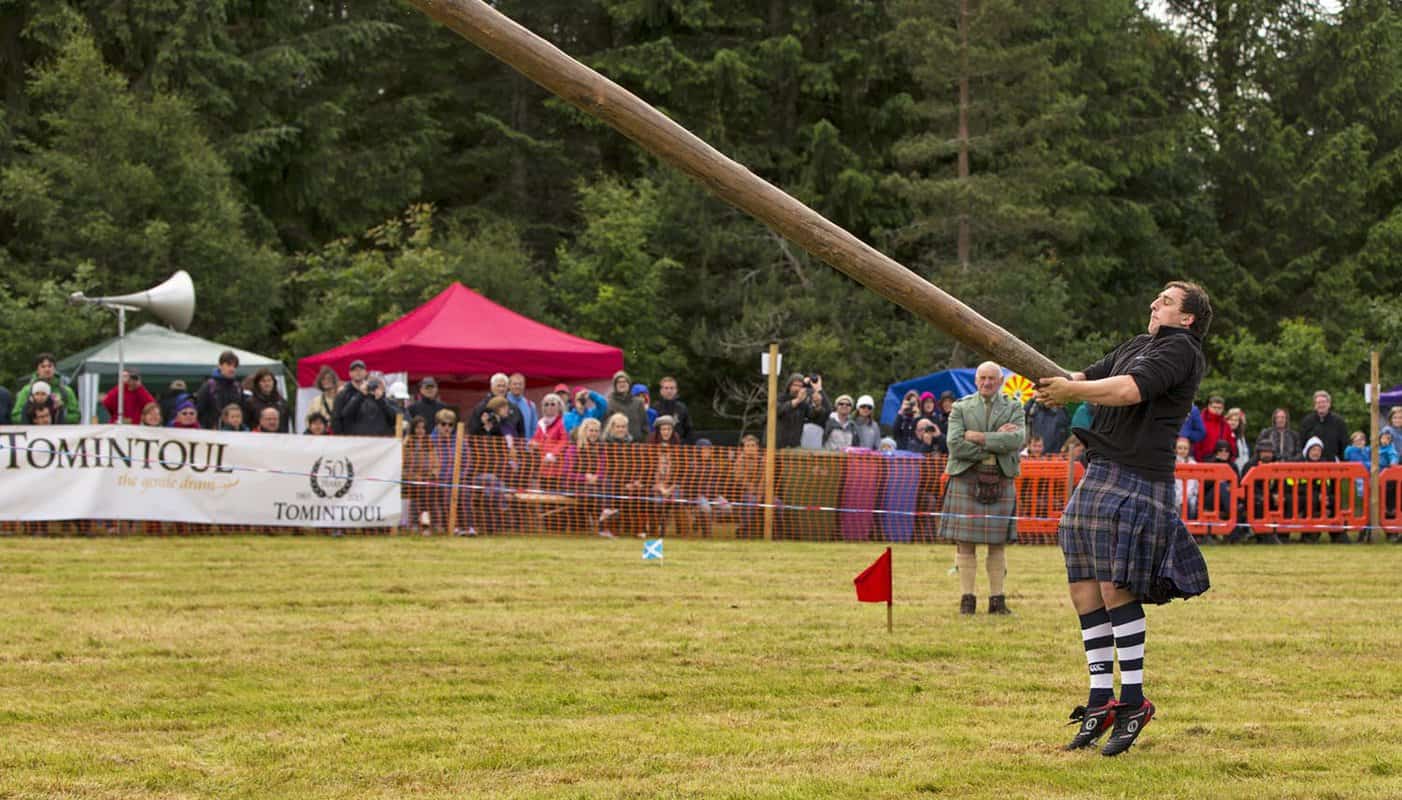 Man tossing a caber