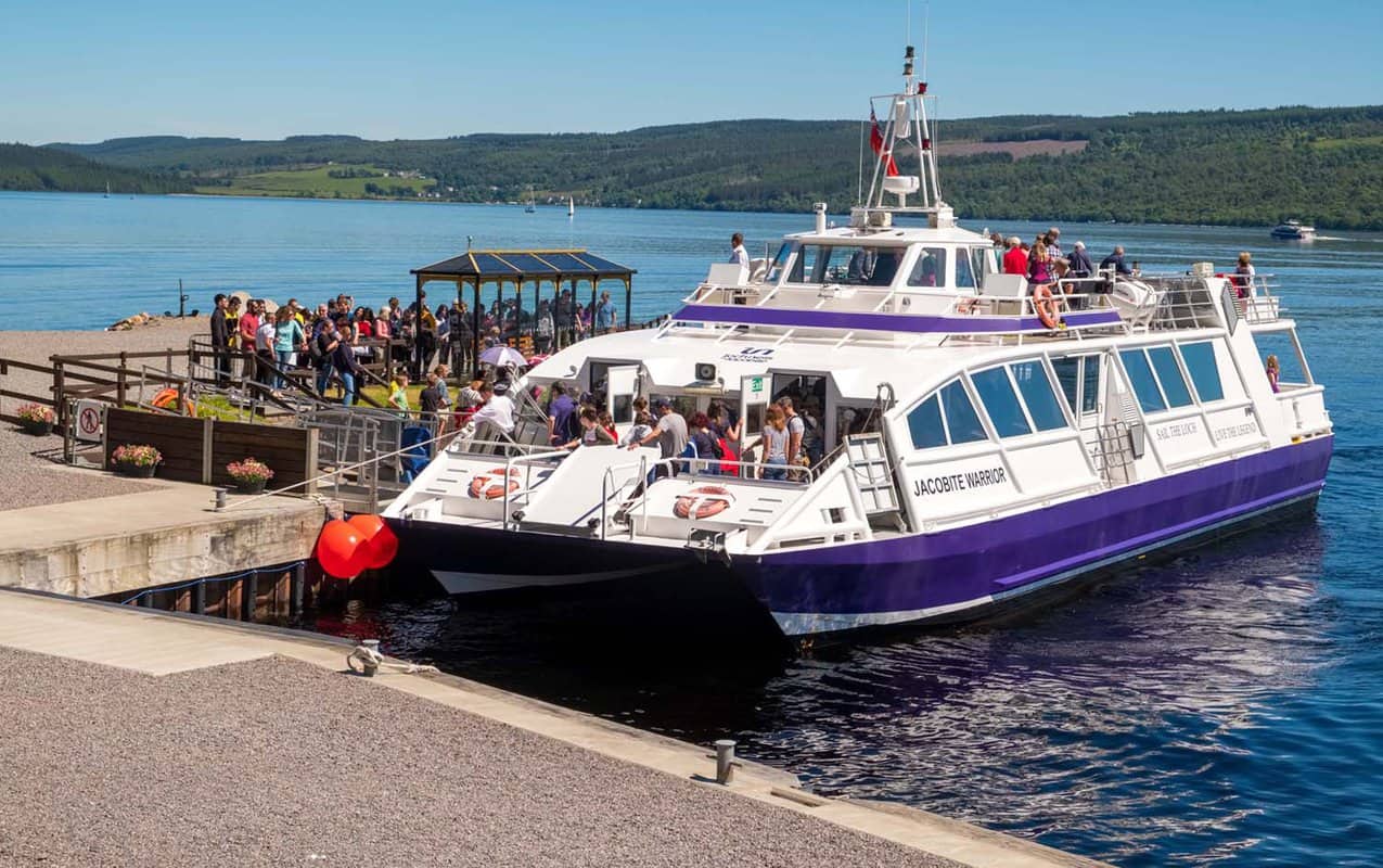 a small ferry boat picking up passengers for a tour of Loch Nesss