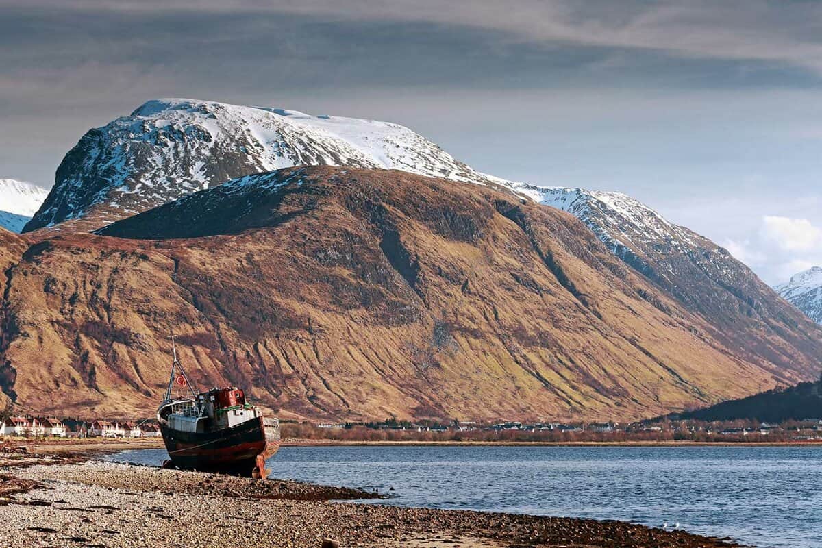 Beautiful view of Ben Nevis rising above a lake with a shipwreck in front