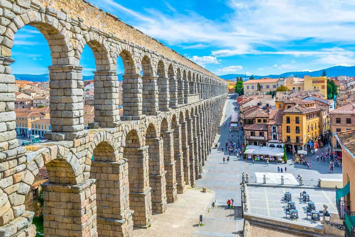People are walking towards famous aqueduct at Segovia, Spain