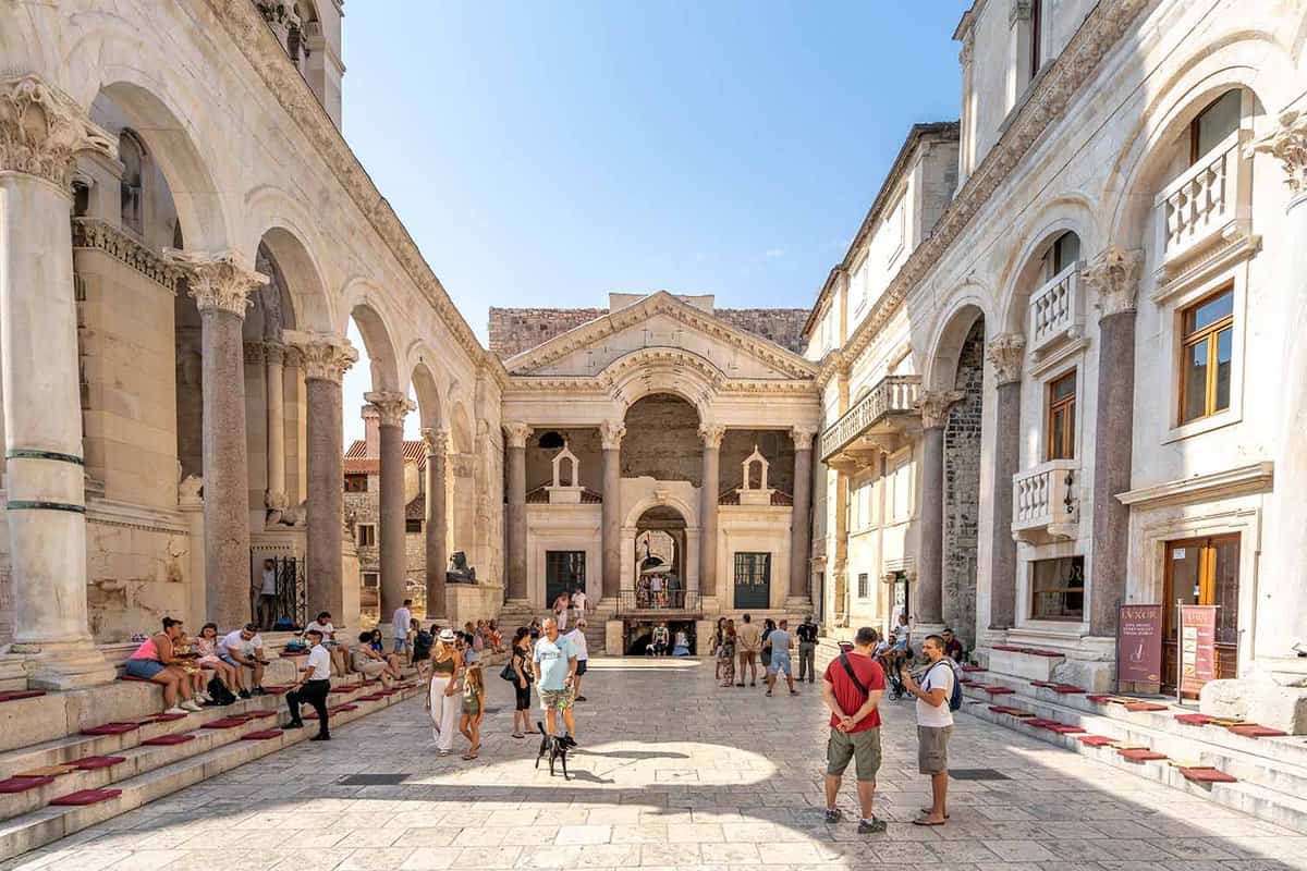 Diocletian's Palace square with tourists in summer morning time