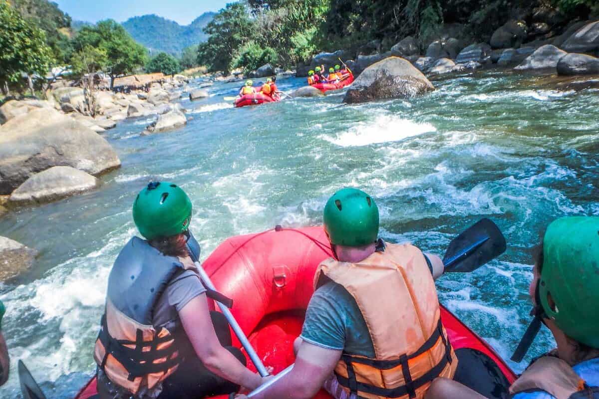 white water rafting with a team of green helmets