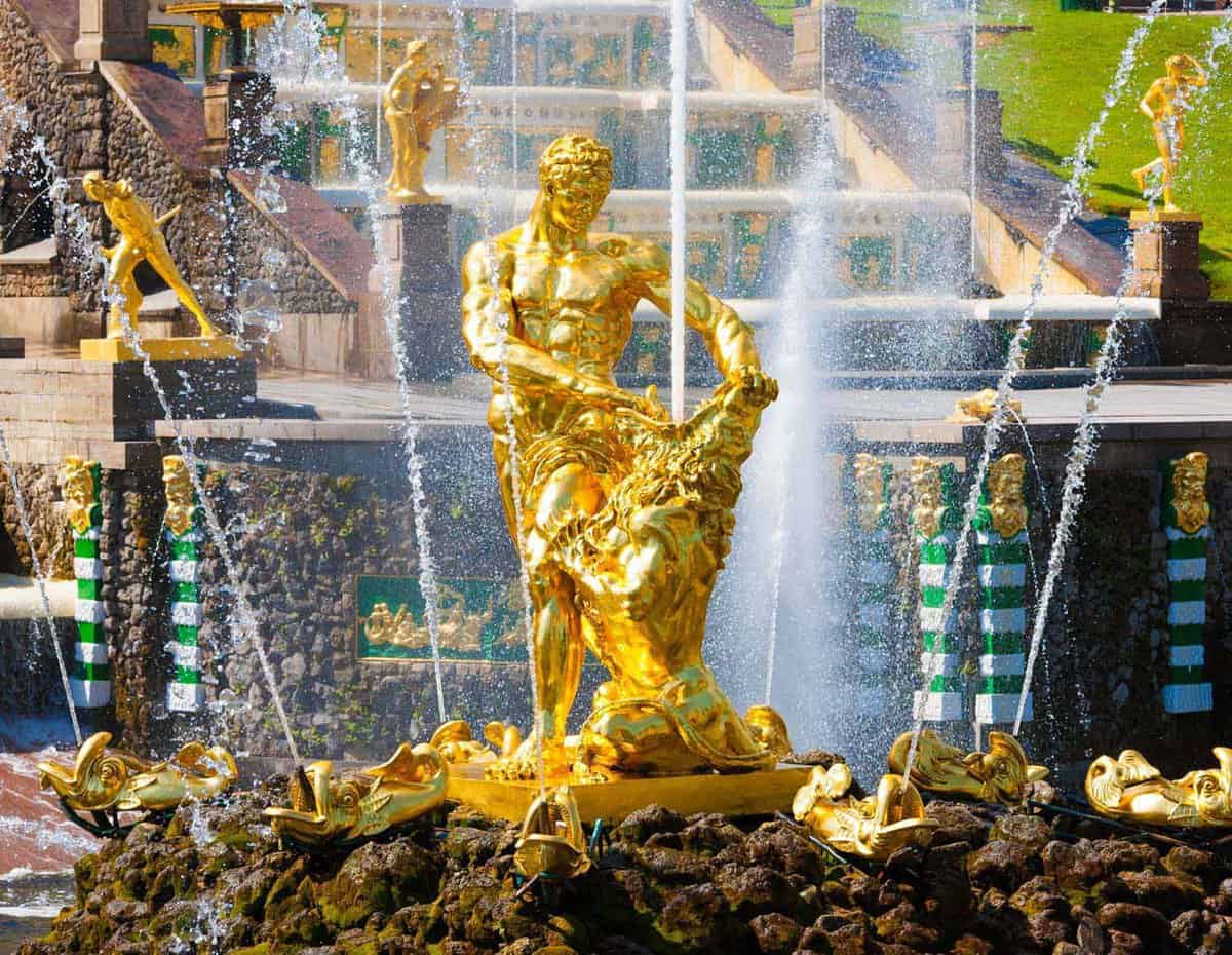 Gold figure in fountain during day
