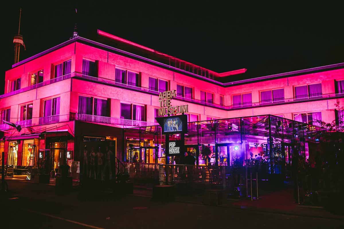 Exterior of Abba Museum lit up pink at night