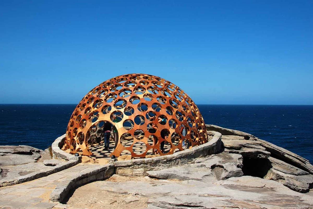 A dome structure by the sea on a sunny day.