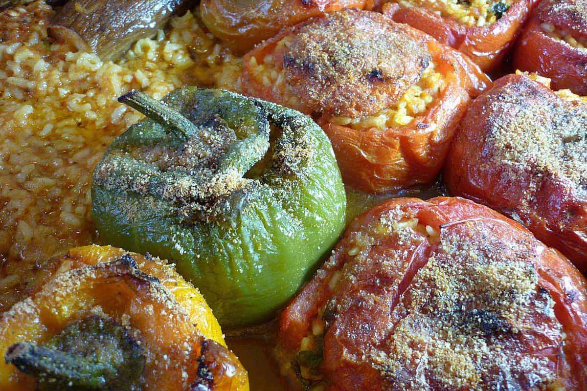 close up of gemista - green and red peppers will with flavoured rice