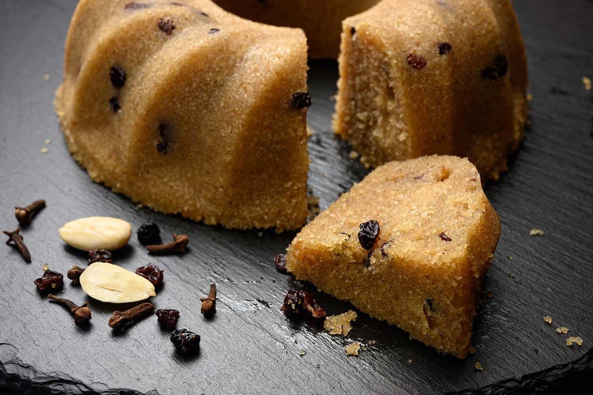 close up of Halva - ground semolina, raisins and almonds boiled with sugar and flavoured with vanilla pods, orange zest and cloves