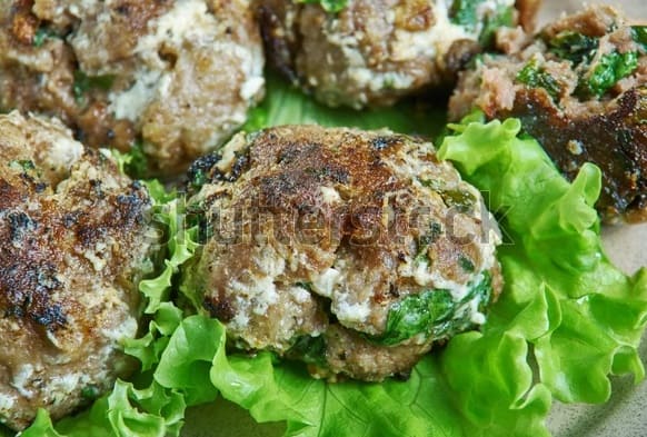 close up of several Kolokythokeftedes - greek vegetarian meatballs