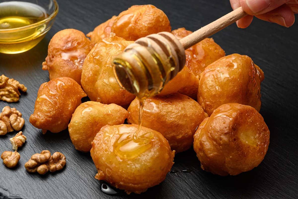 close up of some Loukoumades balls - fluffy, bite-sized dough balls fried in oil, sweetened with honey