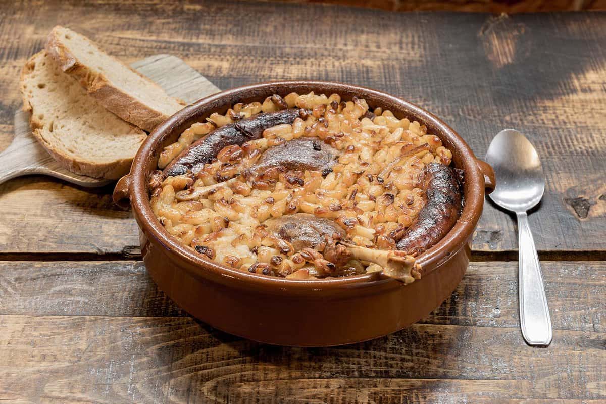 French specialty: cassoulet, a meal with white beans, duck leg, sausage and bacon.