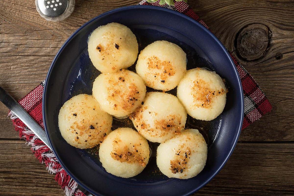 Potato dumplings with meat on a plate.