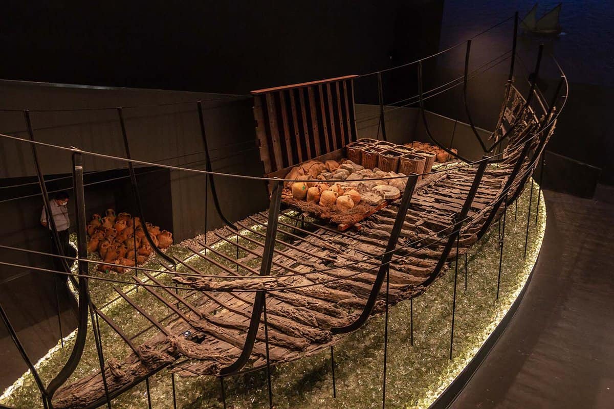 Ruins of an ancient ship set up in a museum exhibit