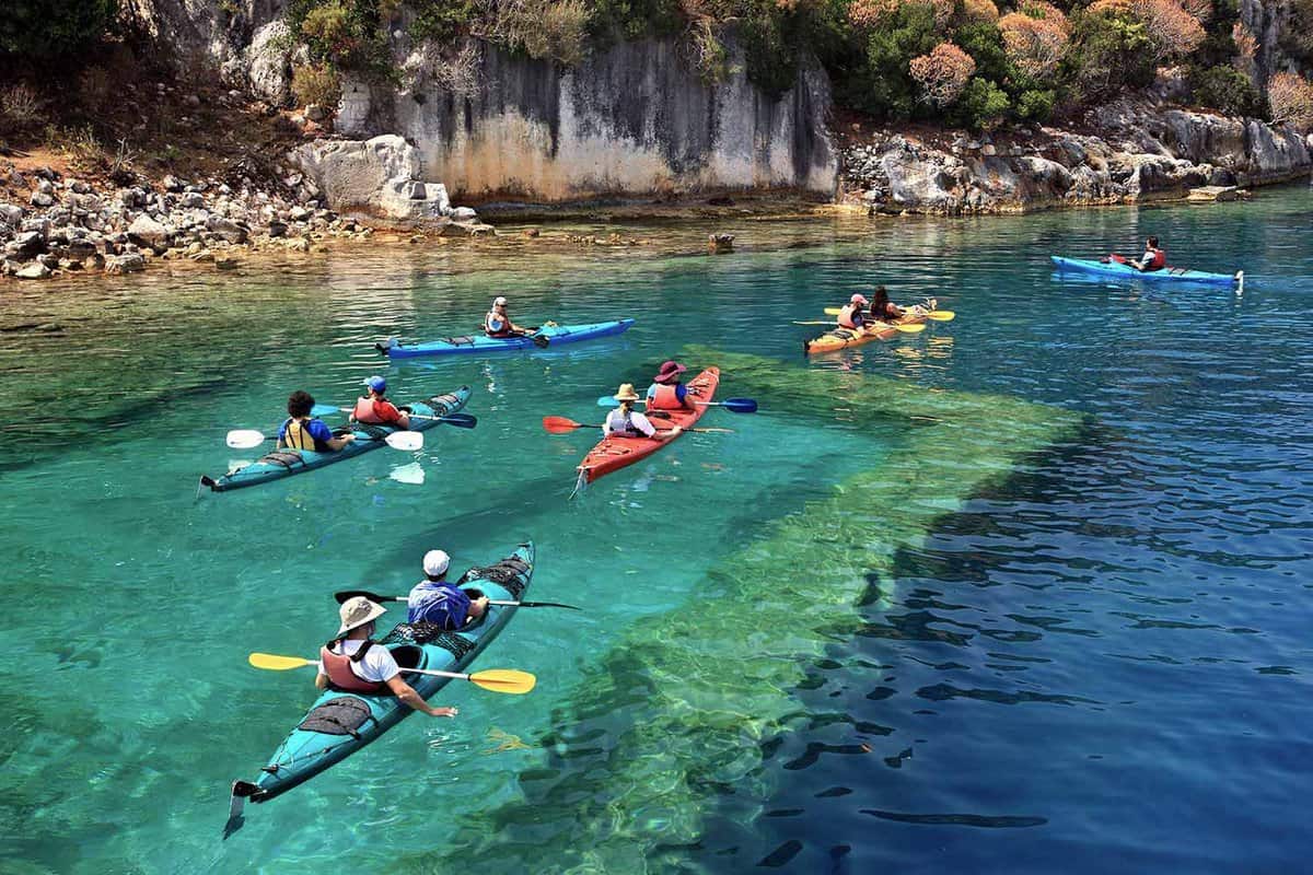 People kayaking on beautiful blue and green water