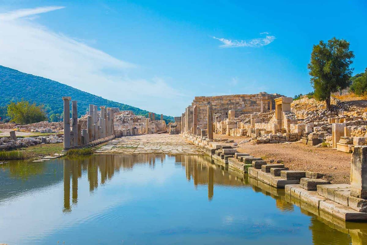 Gorgeous view of the ruins of the ancient city with a blue sky reflected in the water