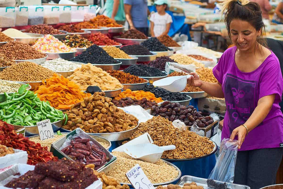 A woman sells nuts and sweets in the market