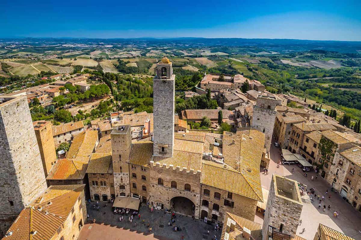 Dizzy top view of the medieval village of San Gimignano near Siena under the sun of Tuscany