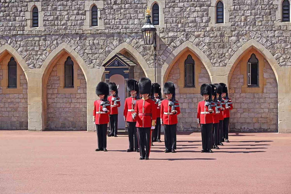 The Royal Guards are lined up and dressed in their red uniform to begin the ceremony of changing the guard at Windsor Castle.