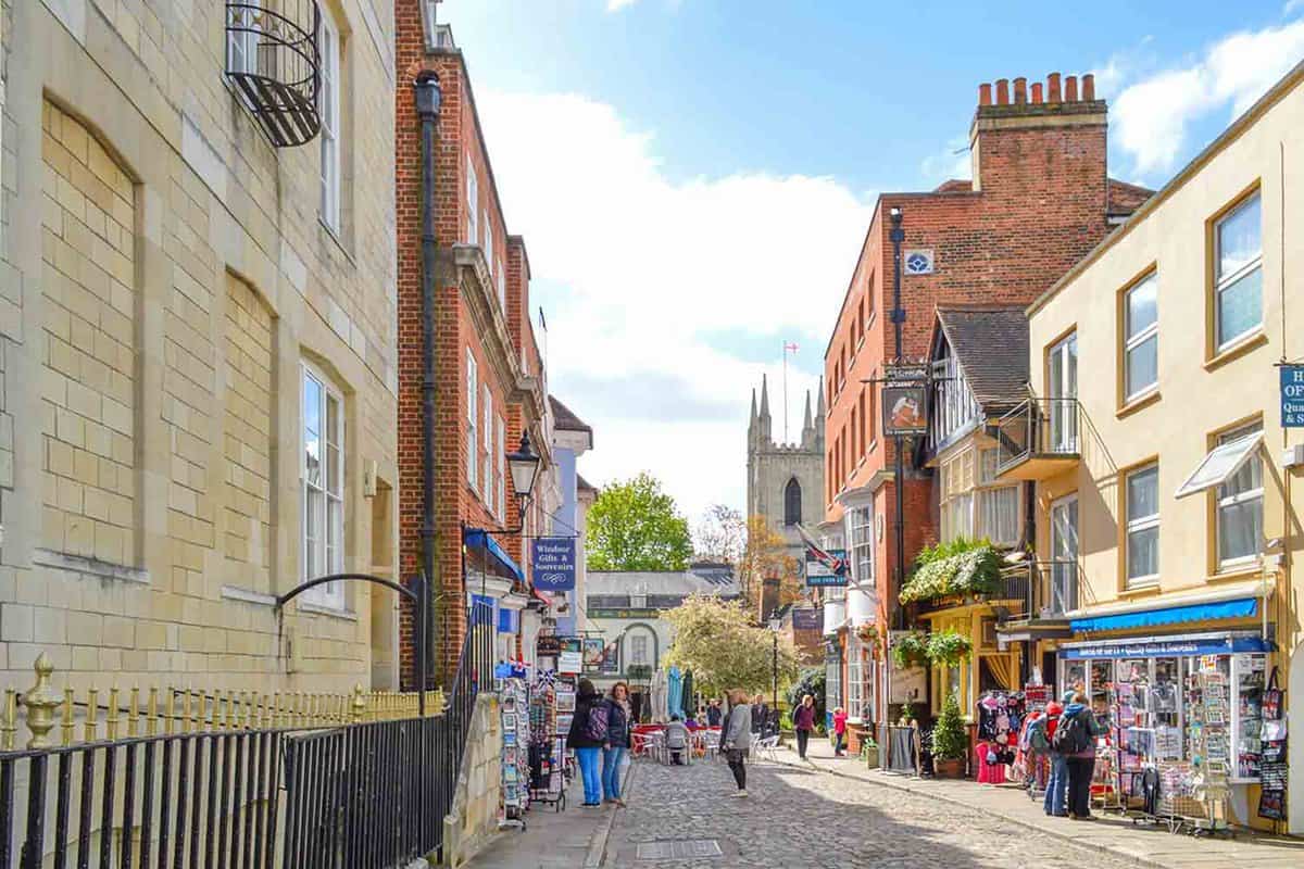 An image of a street in Berkshire where people exploring the near by streets and many shops of Windsor. Windsor is a popular destination in England UK with Windsor castle.