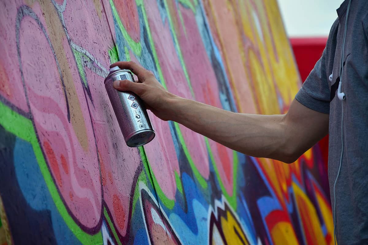 Man spray painting a wall