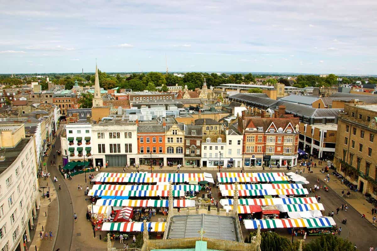 Overhead shot of colourful market stall awnings in the centre of Cambridge