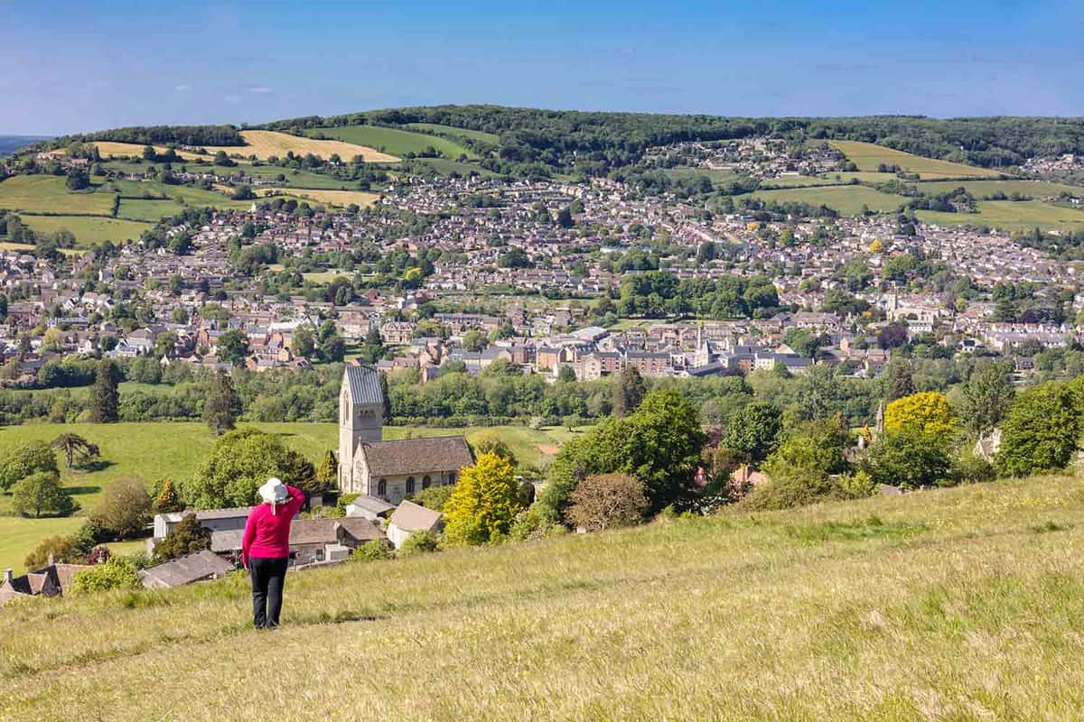 Woman admiring view of lots of houses on a hill.
