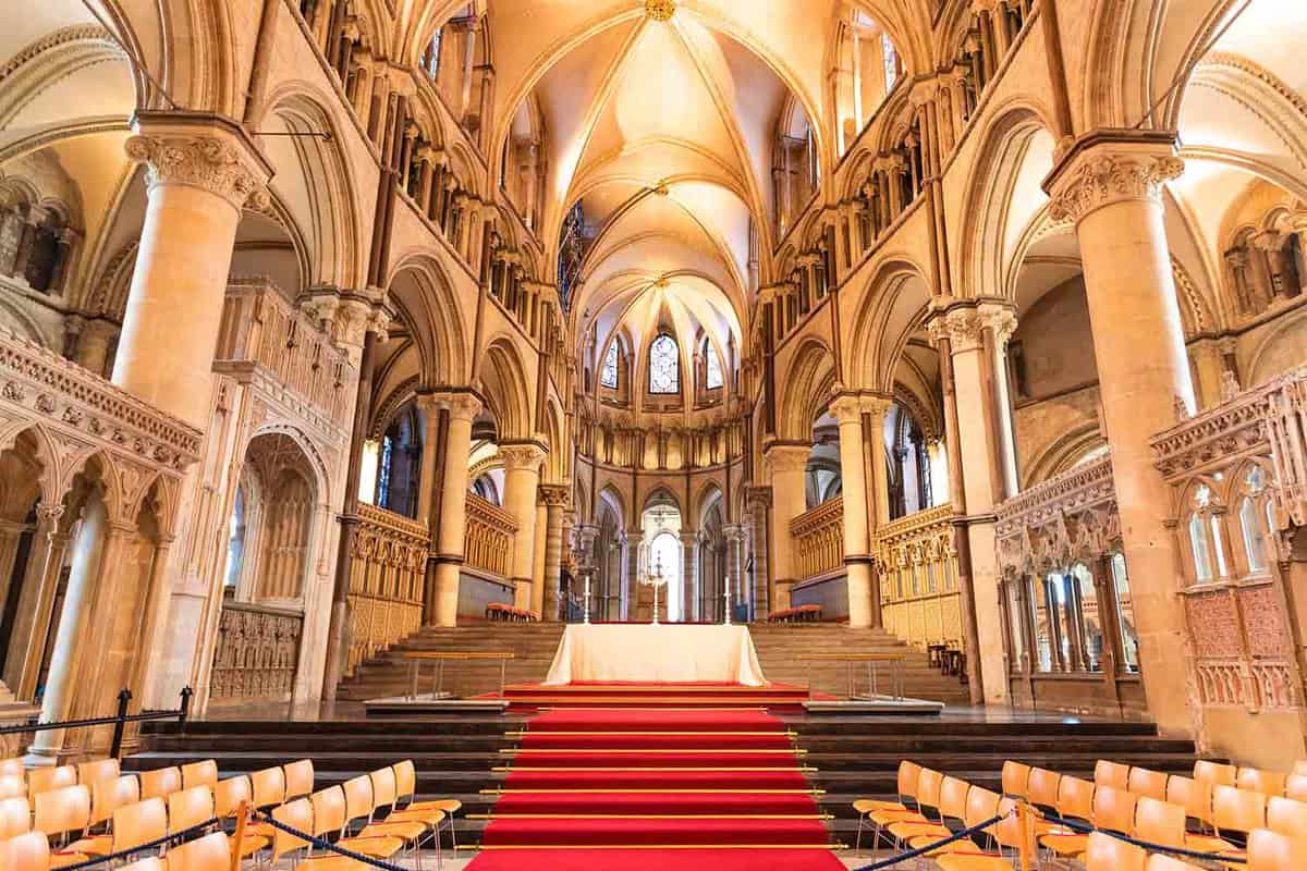 Interior of large cathedral with red carpet leading to the pulpit